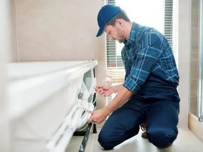 Plumber installing a new bathtub, emphasizing home improvement and spa-like bathroom upgrades.