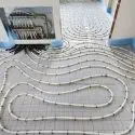 Indoor piping layout for A-Plus Air Conditioning's in-floor radiant heating system with white and blue tiles.