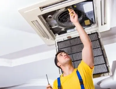 HVAC technician performing maintenance