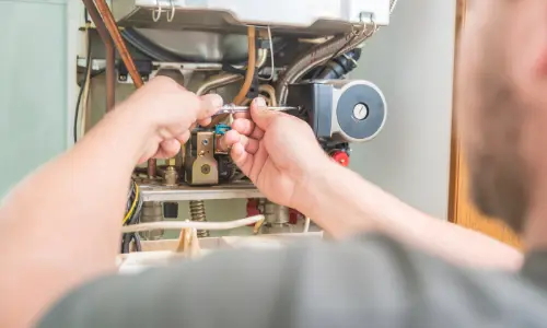 Furnace being repaired by a technician