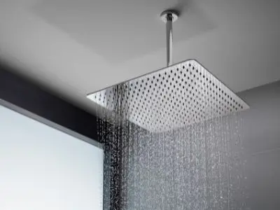 Rainfall showerhead with water cascading down, showcasing a luxurious bathroom upgrade for a spa-like experience at home.