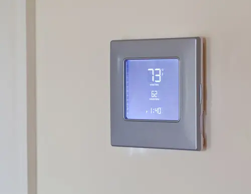 Digital thermostat displaying current temperature and settings, relevant to HVAC services and thermostat malfunction indicators.