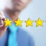Individual in formal attire marking five yellow stars for Atlantic Heating & Air Conditioning's HVAC services review.