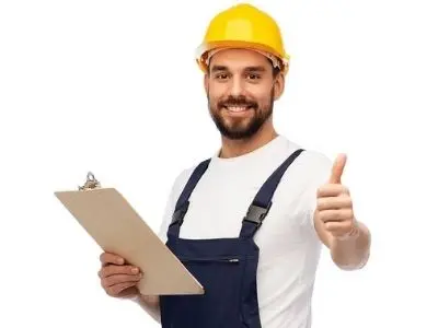 Professional heating technician in a hard hat giving a thumbs-up while holding a clipboard, representing the importance of qualified HVAC services for safe and efficient heater repairs.