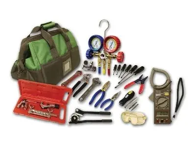 Tool bag with essential HVAC repair tools, including gauges, wrenches, pliers, and a multimeter, illustrating the importance of professional expertise in heater repairs.