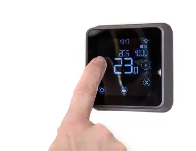 Programmable thermostat with touchscreen display showing temperature settings and time, illustrating efficient home heating solutions.