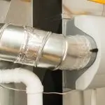 Ventilation duct and vent cover showcasing sleek metallic components for effective humidity control in HVAC systems.