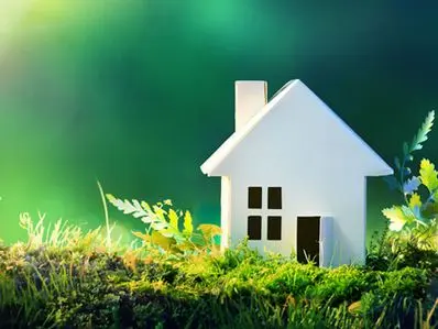 White house model surrounded by greenery, symbolizing energy efficiency and conservation for homeowners in Spring, TX.