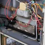 Detailed image of complex electrical components with dense colorful wiring in a metallic framework for HVAC systems.