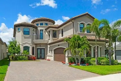 Large, modern home with high ceilings, intricate architectural details, and lush landscaping, emphasizing energy efficiency in residential design.