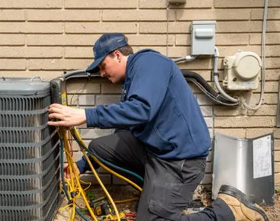 Air conditioner maintenance being performed by a Postma service technician in Chatham-Kent.