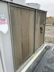 Dirty rooftop AC unit at a commercial property with clogged coils during spring air conditioner maintenance in Chatham-Kent