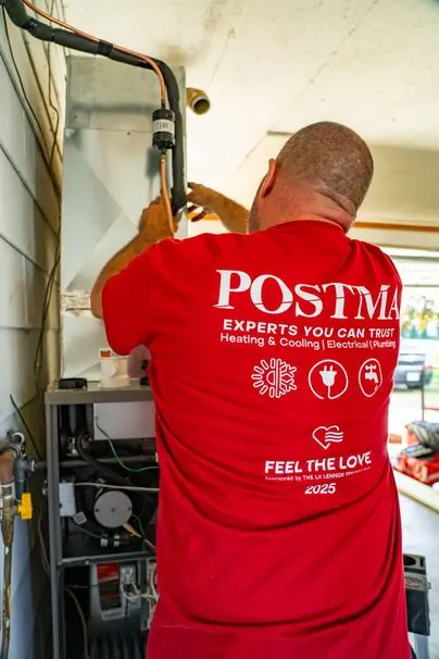 Postma HVAC technician installing high-efficiency furnace in Chatham-Kent Ontario home.