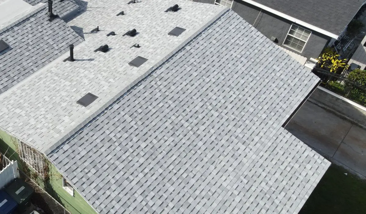 Drone view of a roof with a light grey shingle roof