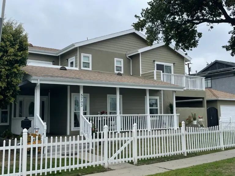 roofing los angeles ca small green house with shingles roof white fence