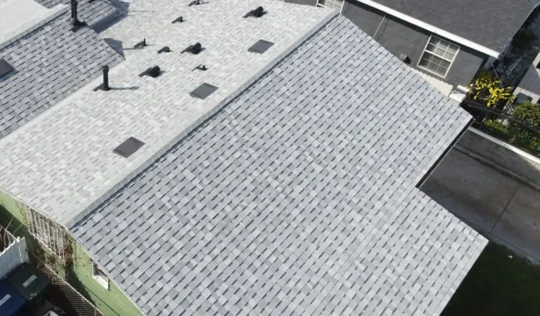 Drone view of a roof with a light grey shingle roof