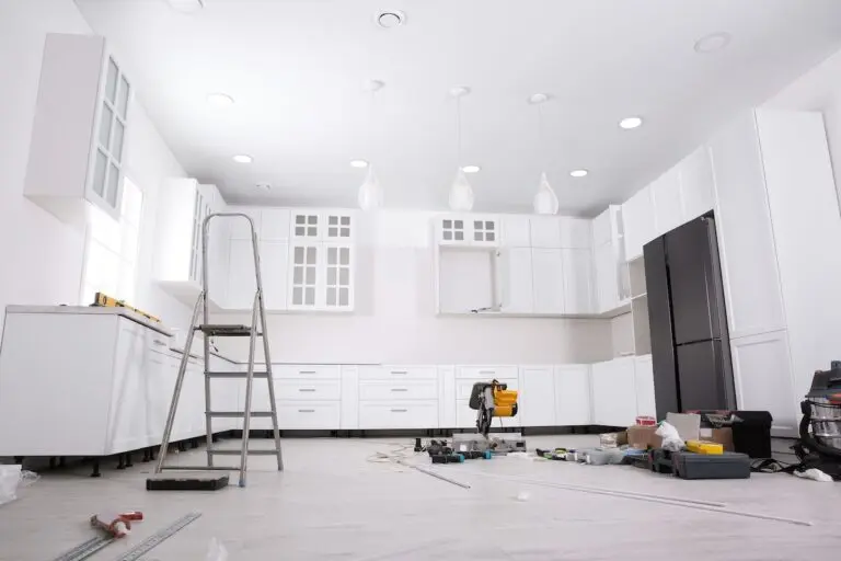 Renovated kitchen interior with stylish furniture, refrigerator and maintenance equipment