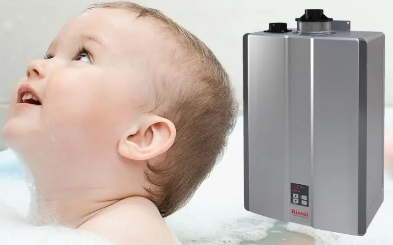 Baby enjoying a bath with bubbles and a Rinnai tankless water heater in the background, illustrating a modern solution for continuous hot water.