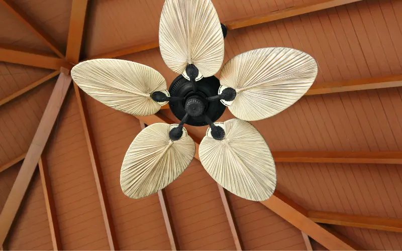 Ceiling fan with decorative leaf-shaped blades, showcasing home comfort solutions relevant to HVAC efficiency and summer cooling strategies.