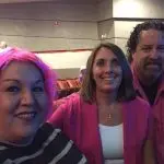 Cheerful group of three with pink-themed outfits, showcasing The Darville Company's plumbing and HVAC expertise.