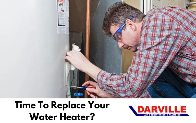technician working to repair a hot water heater