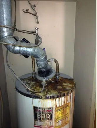 Water heater with rust, corrosion, and stains, showcasing signs of neglect for plumbing maintenance services.