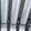 Metal air ducts for HVAC systems, essential for air distribution in homes, illustrating heating and cooling solutions.