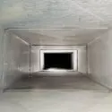 Long metallic ventilation duct showcasing industrial design, relevant for HVAC maintenance tips by Chad's AC Direct.