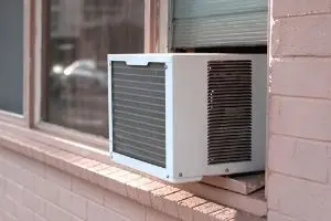 Window HVAC unit installed in a brick wall, emphasizing convenient heating solutions for individual rooms, suitable for holiday decoration without blocking airflow.