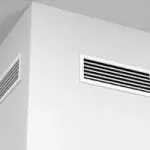 White air vent on wall featuring sleek, modern design for contemporary HVAC aesthetics by Chad's AC Direct.