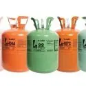 Various labeled gas cylinders in shades of green and orange, organized for HVAC safety efficiency at Chad's AC Direct.