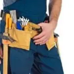 Person wearing a tool belt with various tools, representing HVAC repair readiness for Chad's AC Direct services.