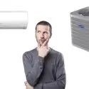 A man evaluating a wall-mounted and freestanding air conditioning unit for home HVAC options from Chad's AC Direct.