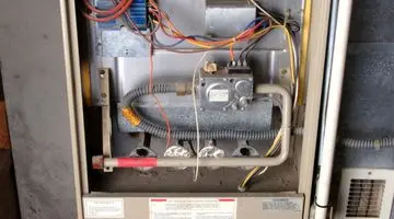 Heater components with visible wiring and gas lines, illustrating the internal mechanisms relevant to heater repair and maintenance.