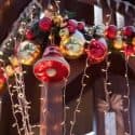 Festive Christmas decorations featuring red and gold ornaments, string lights, and greenery at Chad's AC Direct.