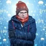 A person in winter attire shivering outdoors, highlighting HVAC challenges in cold weather for Chad's AC Direct services.