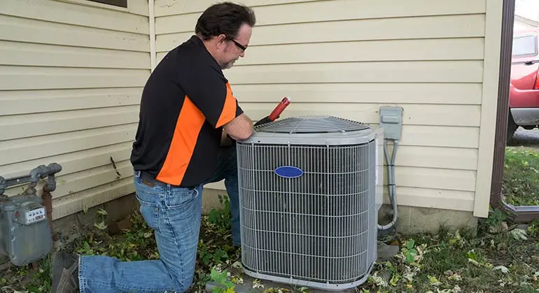 Technician servicing an air handler unit for HVAC systems, emphasizing installation and repair services by Chris Wilson Plumbing & Heating Repairs Inc.