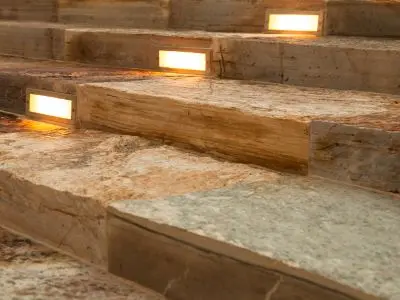 Outdoor steps illuminated with integrated lighting fixtures, enhancing safety and aesthetic appeal for porches and patios.
