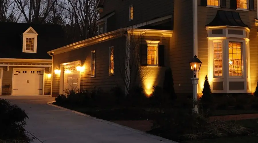 House and garage with illuminated windows and lamp post, showcasing The Bosworth Company's services.