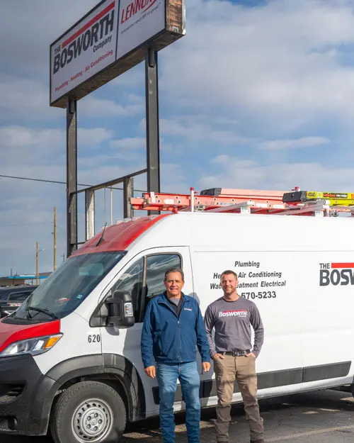 The Bosworth Company service van with two technicians standing in front, showcasing gas fireplace repair and installation services in Midland, TX.
