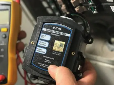 Eaton whole house surge protector being installed, emphasizing electrical safety and protection for home electronics against power surges.