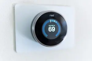 Thermostat displaying a temperature setting of 69 degrees Fahrenheit, representing home heating control for optimal comfort during winter, relevant to HVAC services offered by The Meridian Company.