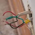 Electrical wiring and outlet installation showcasing exposed wires for safety inspections by The Meridian Company.