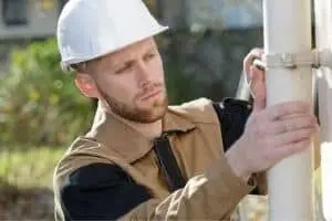 a plumber installing a pipe