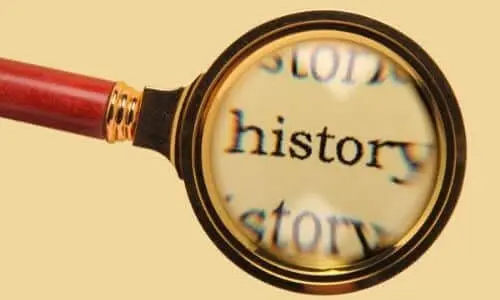Magnifying glass focusing on the word "history," symbolizing the exploration of air conditioning's historical development and significance.