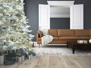 Cozy living room with a decorated Christmas tree, brown couch, and elegant decor, highlighting seasonal home improvement and maintenance themes.