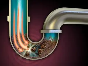 Illustration of a clogged drain pipe with visible debris and buildup, emphasizing plumbing issues relevant to home maintenance and services offered by The Meridian Company.