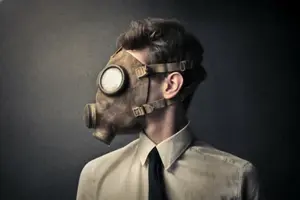 Person wearing a gas mask and formal attire, symbolizing safety and protection in hazardous environments related to HVAC services and air quality concerns.