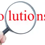 Hand holding a magnifying glass focusing on "Solutions" in bold red text for HVAC and home improvement insights.