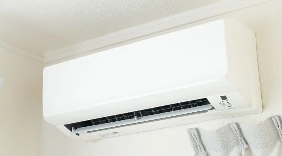 Ductless mini split air conditioner mounted on a wall, illustrating efficient heating and cooling solutions for homes.